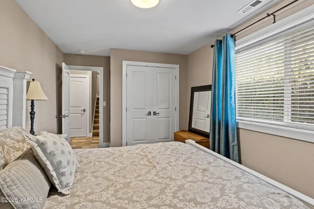 a bedroom with a bed and a window