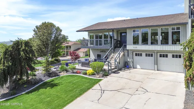 a front view of a house with garden and sitting area
