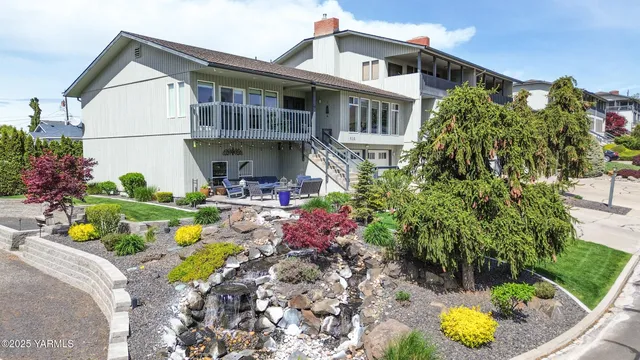 a front view of a house with a yard and fountain
