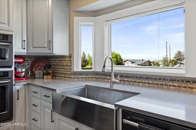 a kitchen with stainless steel appliances a sink stove and cabinets