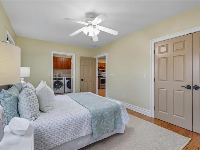 a bedroom with a large bed and a chandelier