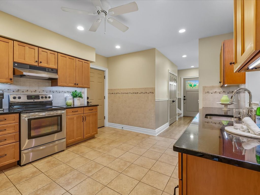 217 Huntington Road Stratford, CT 06614 - Photo 14 of 39 a kitchen with stainless steel appliances granite countertop a refrigerator a stove and a sink with cabinets
