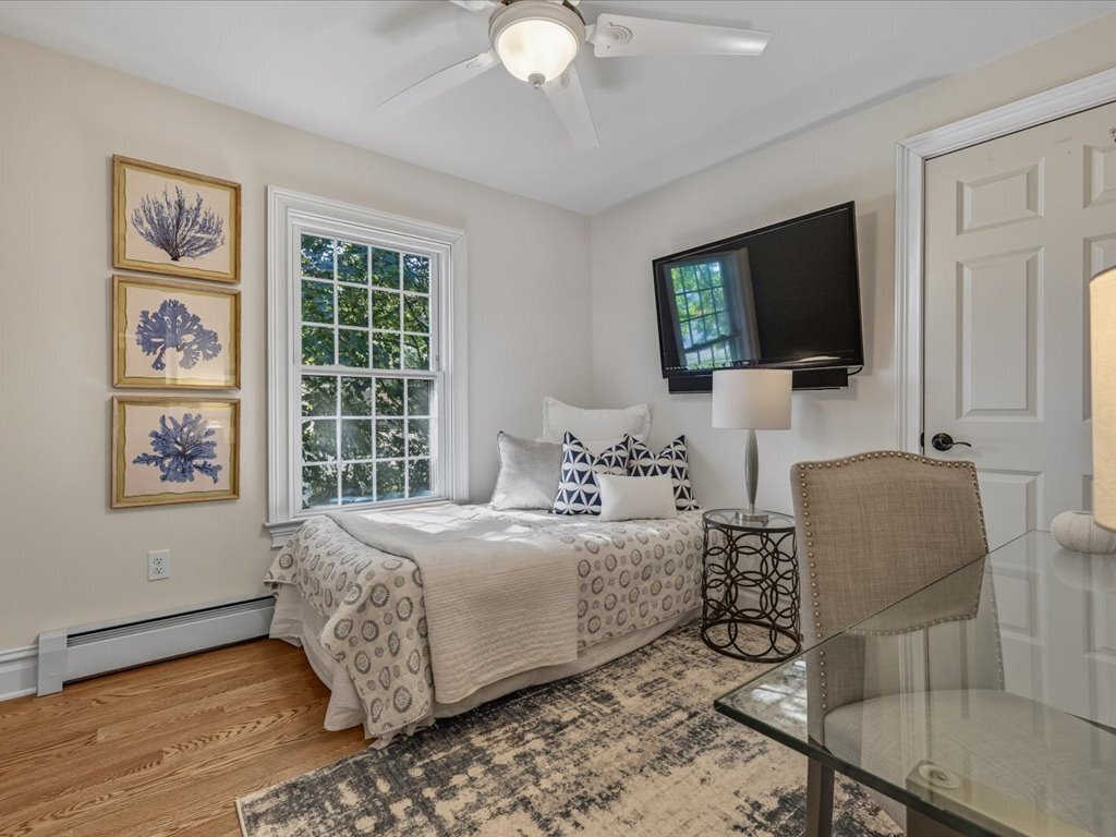 217 Huntington Road Stratford, CT 06614 - Photo 23 of 39 a bedroom with a bed a couch and a flat screen tv