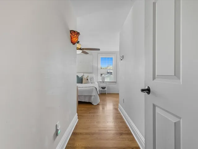a view of a bedroom with sink bed and wooden floor
