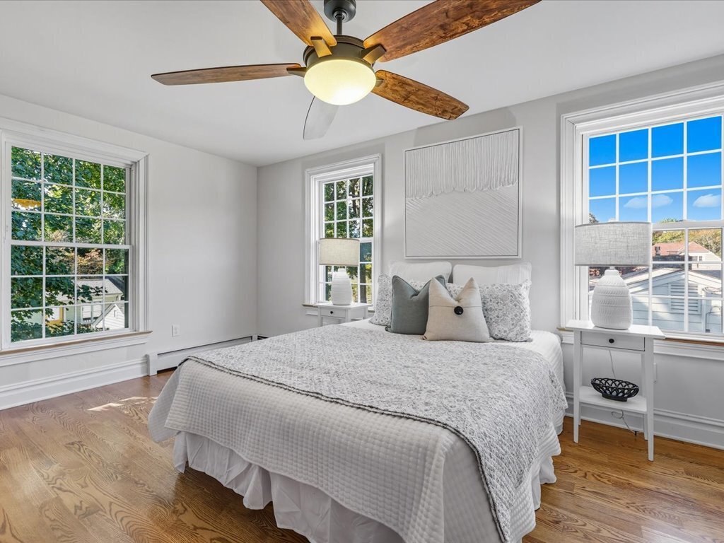 217 Huntington Road Stratford, CT 06614 - Photo 26 of 39 a bedroom with a large bed and a chandelier fan