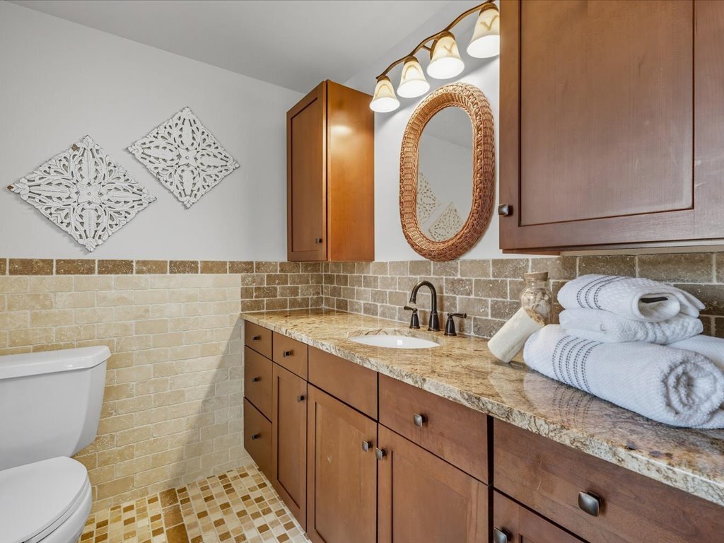 217 Huntington Road Stratford, CT 06614 - Photo 28 of 39 a bathroom with a granite countertop toilet sink and mirror