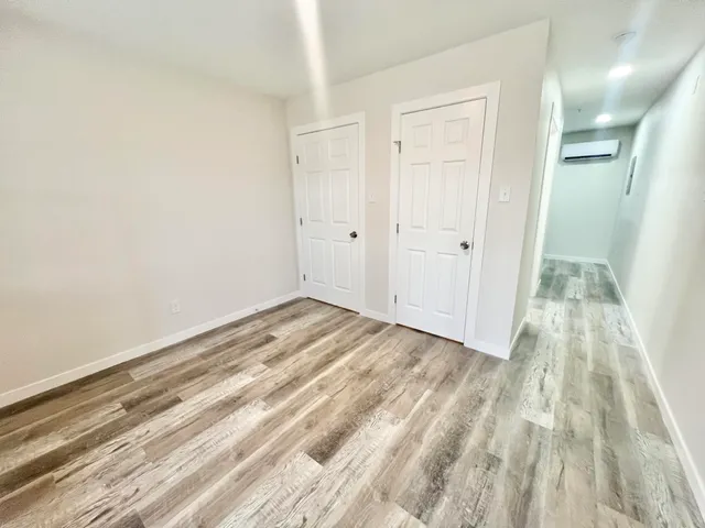 a view of a room with wooden floor and white doors