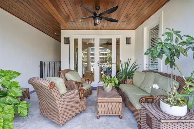 a living room with furniture and a potted plant