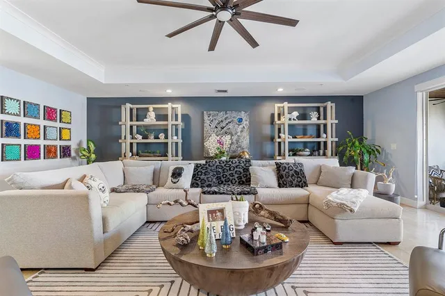 a living room with furniture and a book shelf