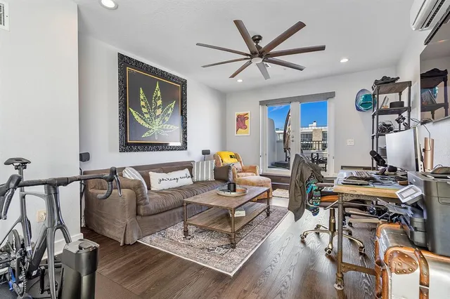 a living room with furniture a ceiling fan and a window