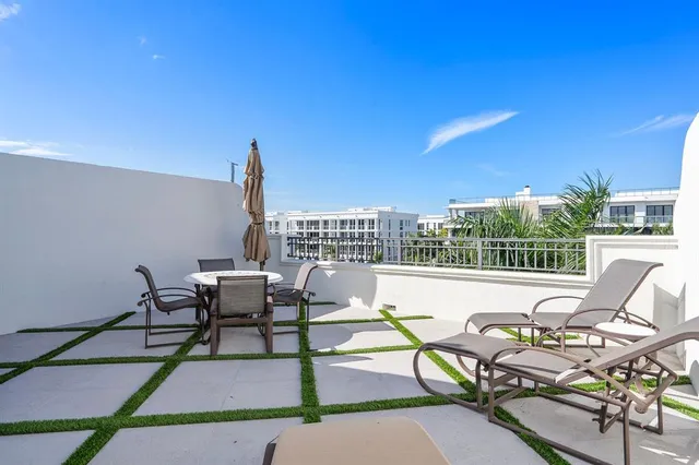 a view of a patio with a table and chairs
