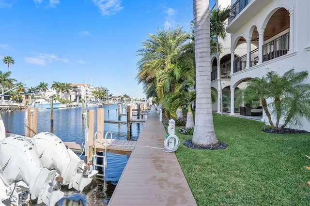 a view of a patio with a table and chairs next to a yard