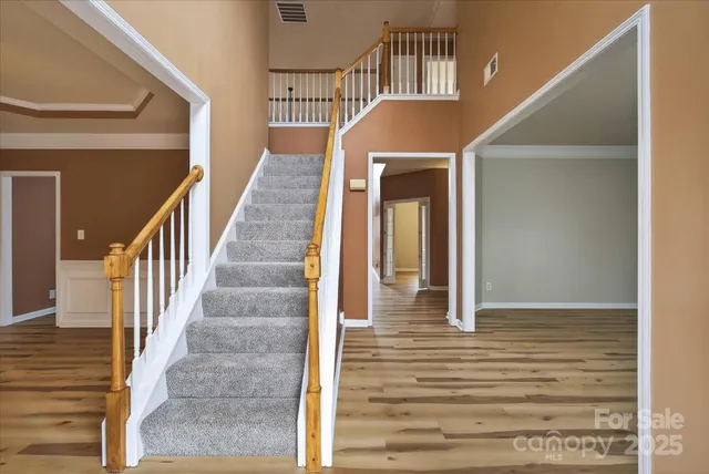 a kitchen with stainless steel appliances granite countertop a stove top oven a sink dishwasher and a refrigerator