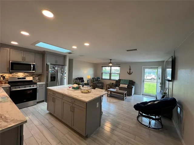 a kitchen with a sink a counter top space and appliances