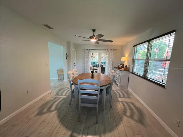 a view of a dining room with furniture window and wooden floor
