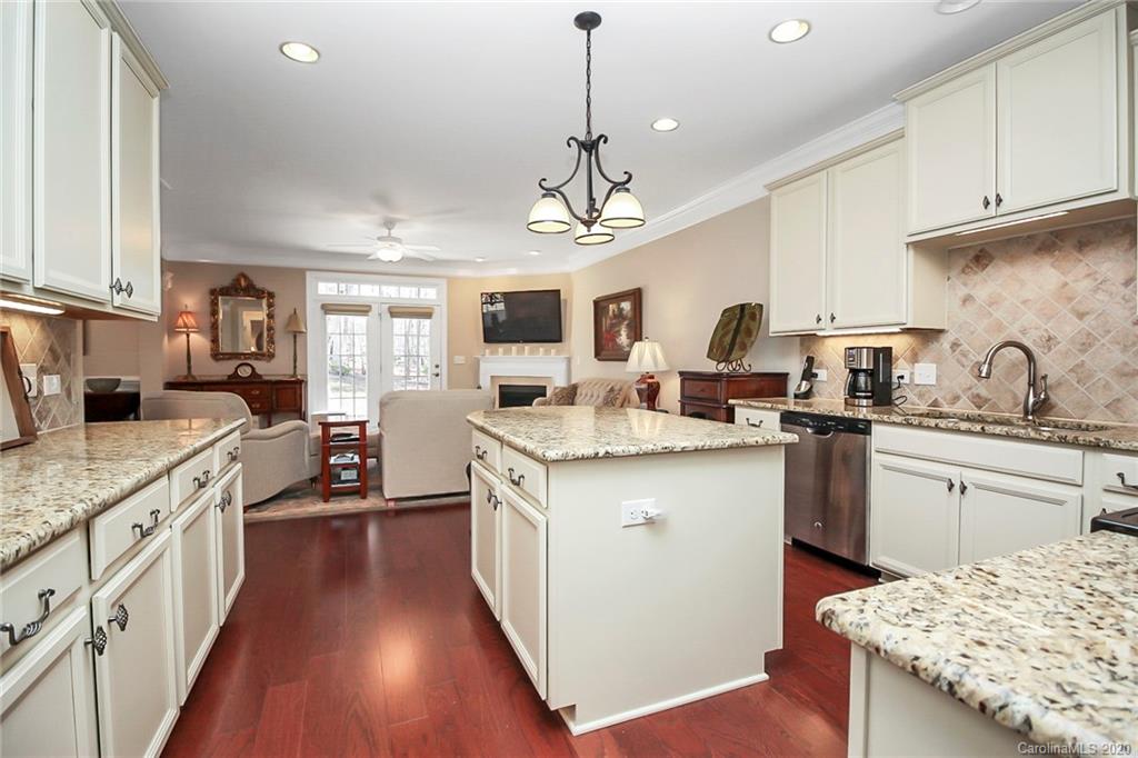 911 Ospre Lane Fort Mill, SC 29708 - Photo 15 of 45 a kitchen with granite countertop a sink cabinets stainless steel appliances and a counter top space