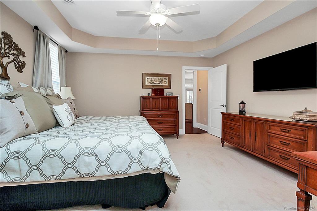 911 Ospre Lane Fort Mill, SC 29708 - Photo 20 of 45 a bedroom with a bed and a flat tv screen on dresser