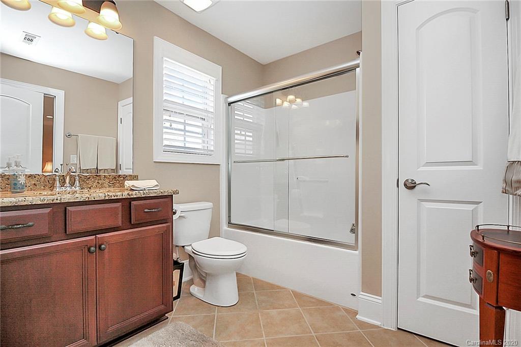 911 Ospre Lane Fort Mill, SC 29708 - Photo 30 of 45 a bathroom with a granite countertop sink toilet and shower