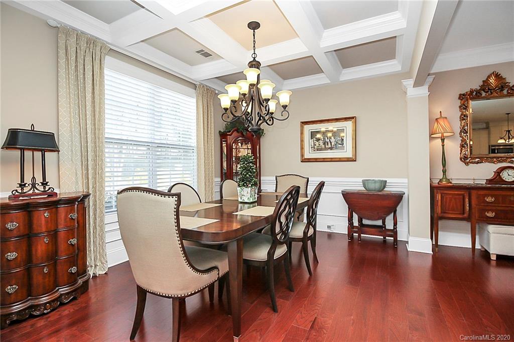 911 Ospre Lane Fort Mill, SC 29708 - Photo 4 of 45 a dining room with furniture a chandelier and wooden floor