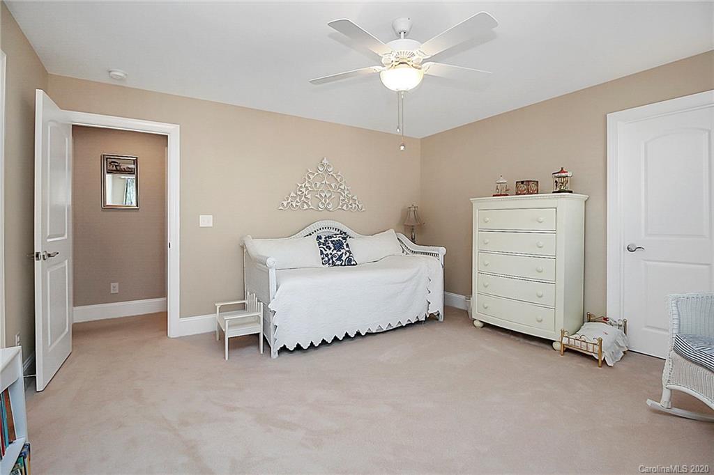 911 Ospre Lane Fort Mill, SC 29708 - Photo 32 of 45 a spacious bedroom with a bed and a ceiling fan