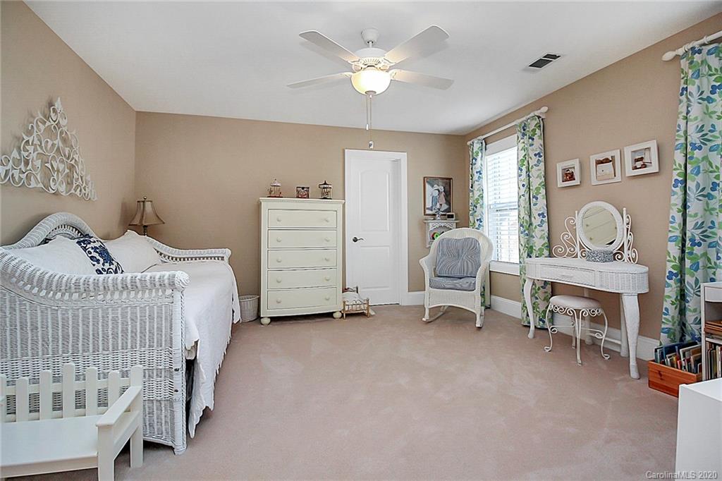 911 Ospre Lane Fort Mill, SC 29708 - Photo 33 of 45 a bedroom with a bed and a chandelier
