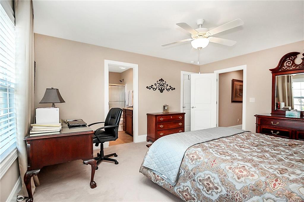 911 Ospre Lane Fort Mill, SC 29708 - Photo 38 of 45 a bedroom with a bed and a chandelier