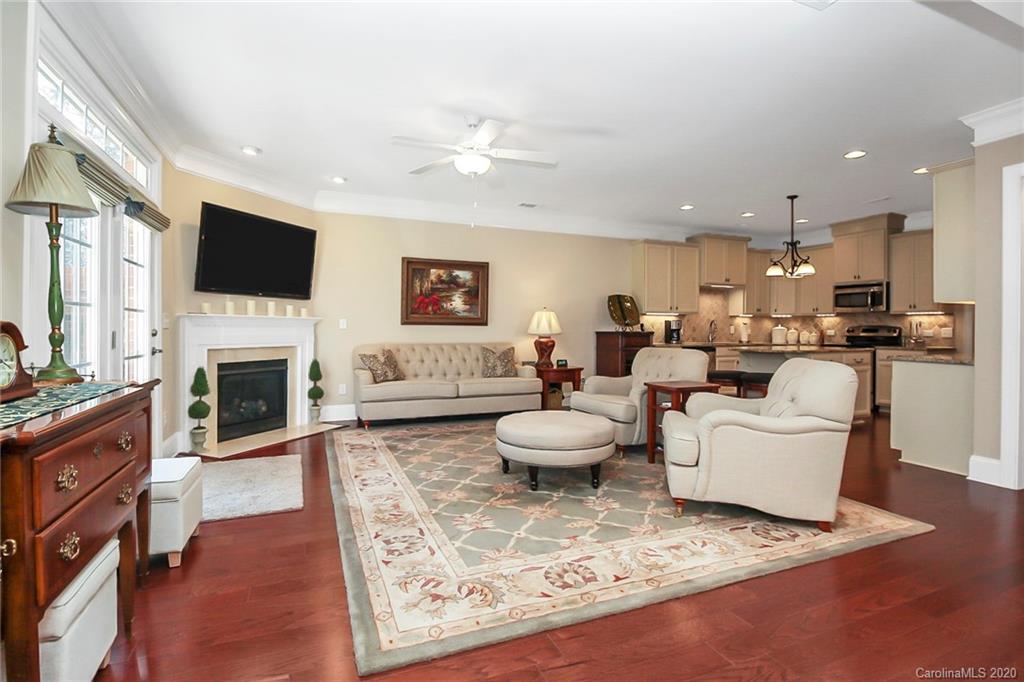 911 Ospre Lane Fort Mill, SC 29708 - Photo 7 of 45 a living room with furniture a flat screen tv and a fireplace