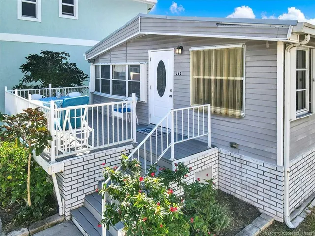 a view of porch with wooden chairs