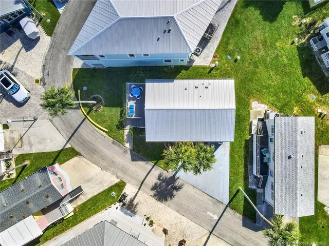 a aerial view of a house with garden space and street view