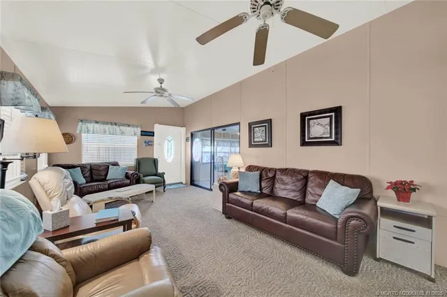 a living room with furniture and a ceiling fan