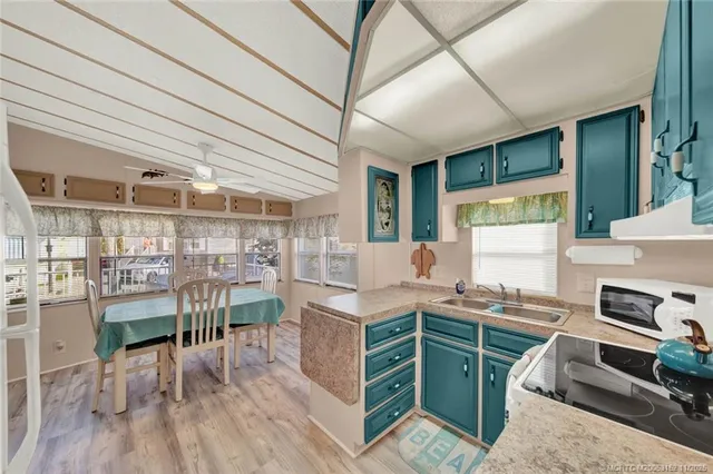 a kitchen with a table chairs and a wooden floor