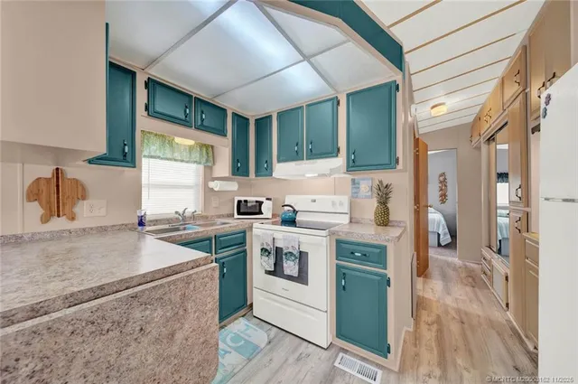 a kitchen with a stove a sink and a refrigerator
