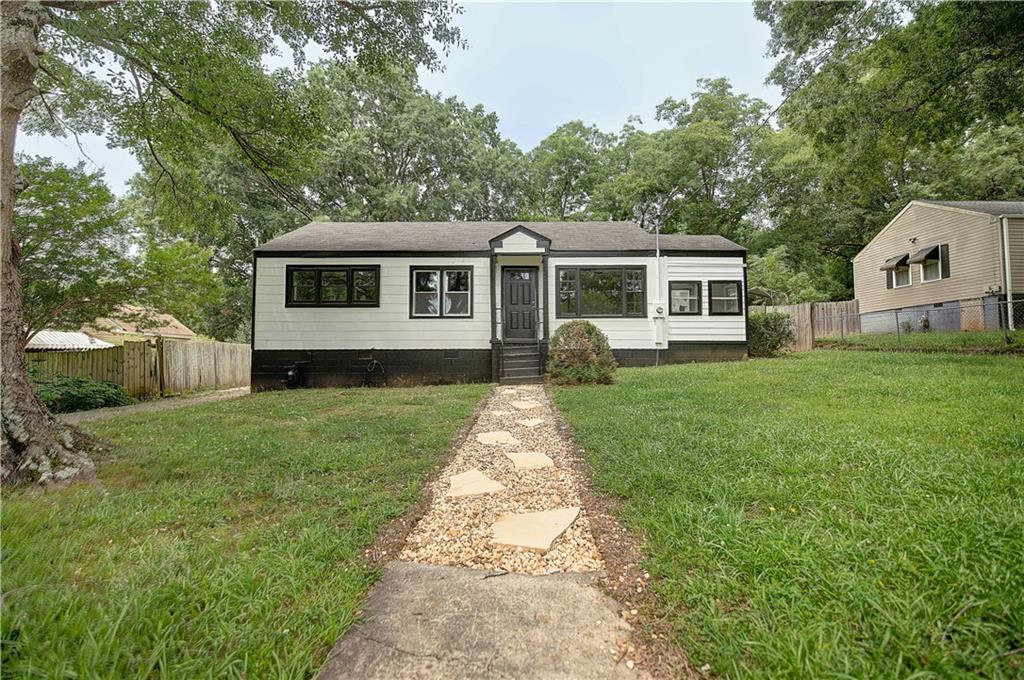 117 Juniper Way Southeast Rome, GA 30161 - Photo 1 of 1 a front view of a house with a garden and trees