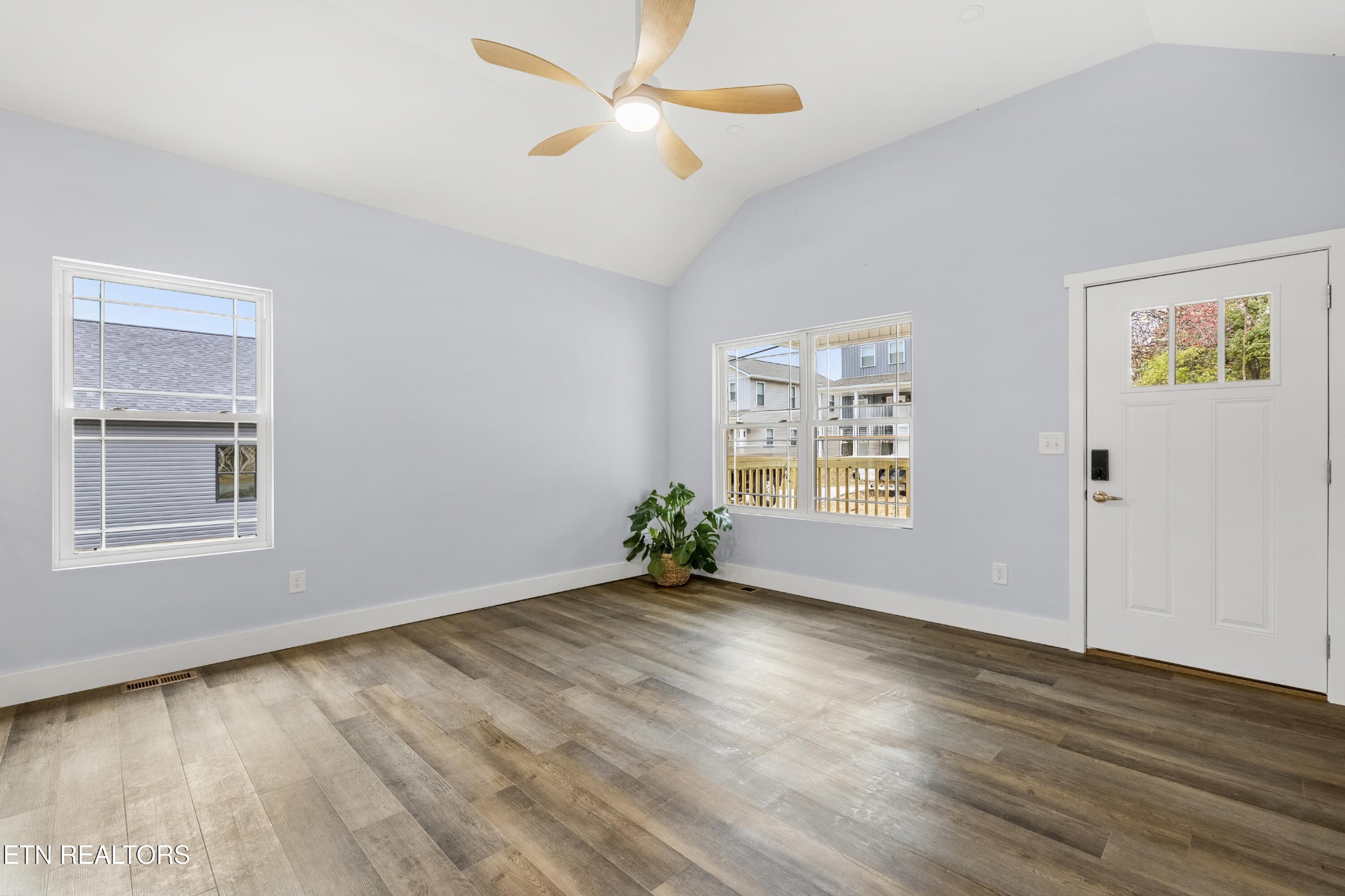 3436 Gap Road Knoxville, TN 37921 - Photo 7 of 25 an empty room with wooden floor chandelier fan and windows
