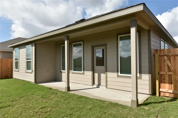 a view of a house with backyard and porch