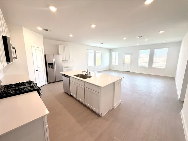 a kitchen with a refrigerator and a sink