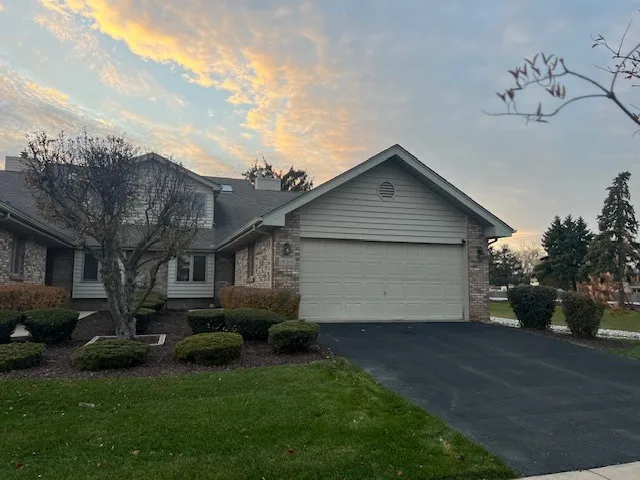 a front view of house with backyard and green space