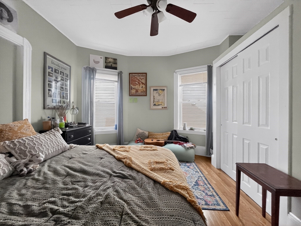 49 Porter Street Somerville, MA 02143 - Photo 12 of 40 a bedroom with a bed and wooden floor
