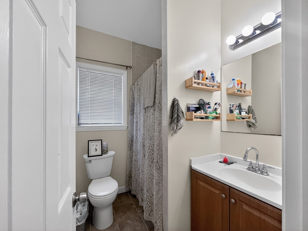 49 Porter Street Somerville, MA 02143 - Photo 15 of 40 a bathroom with a sink toilet and a mirror
