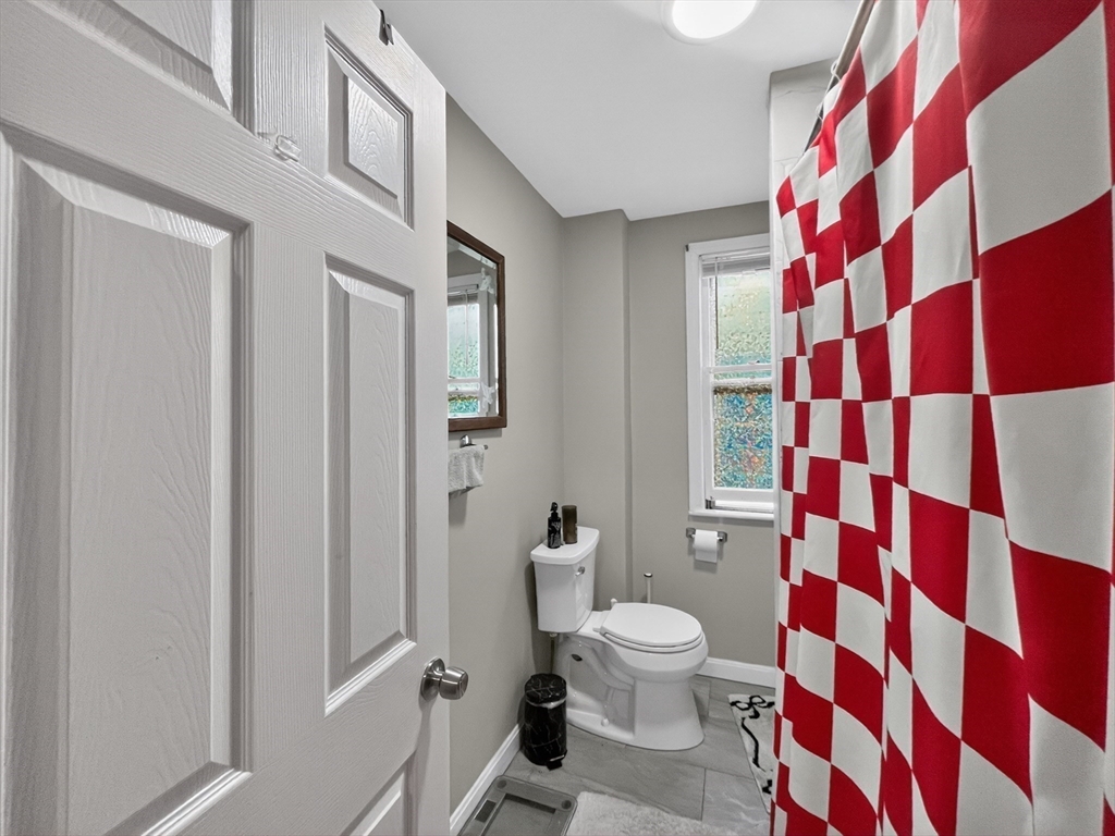 49 Porter Street Somerville, MA 02143 - Photo 16 of 40 a white toilet sitting next to a shower curtain