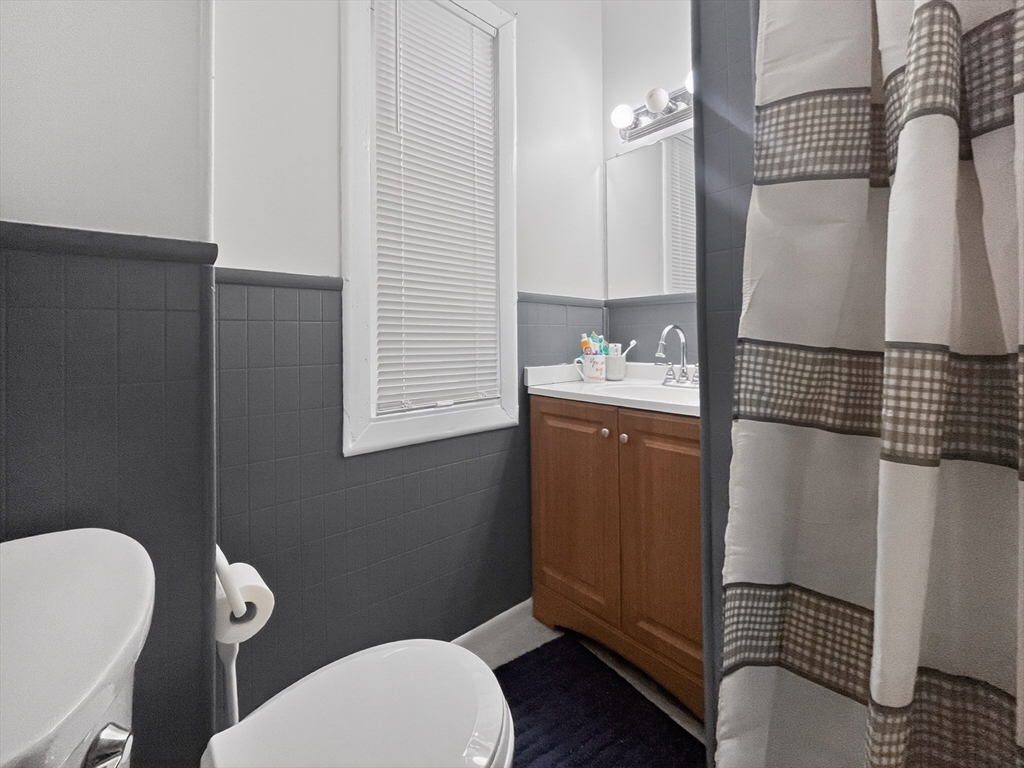 49 Porter Street Somerville, MA 02143 - Photo 17 of 40 a bathroom with a toilet a sink and bathtub