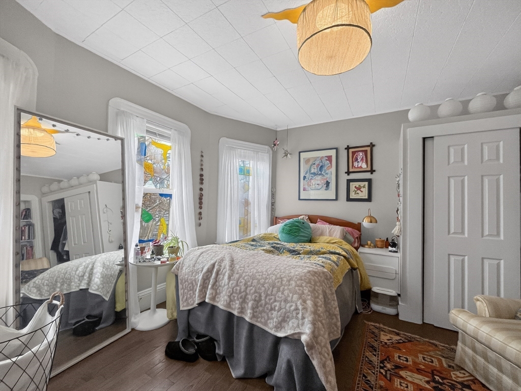 49 Porter Street Somerville, MA 02143 - Photo 25 of 40 a bedroom with a bed and a chandelier