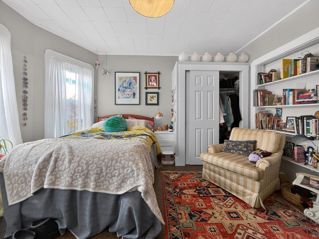 49 Porter Street Somerville, MA 02143 - Photo 29 of 40 a bedroom with a bed a couch and bookshelf