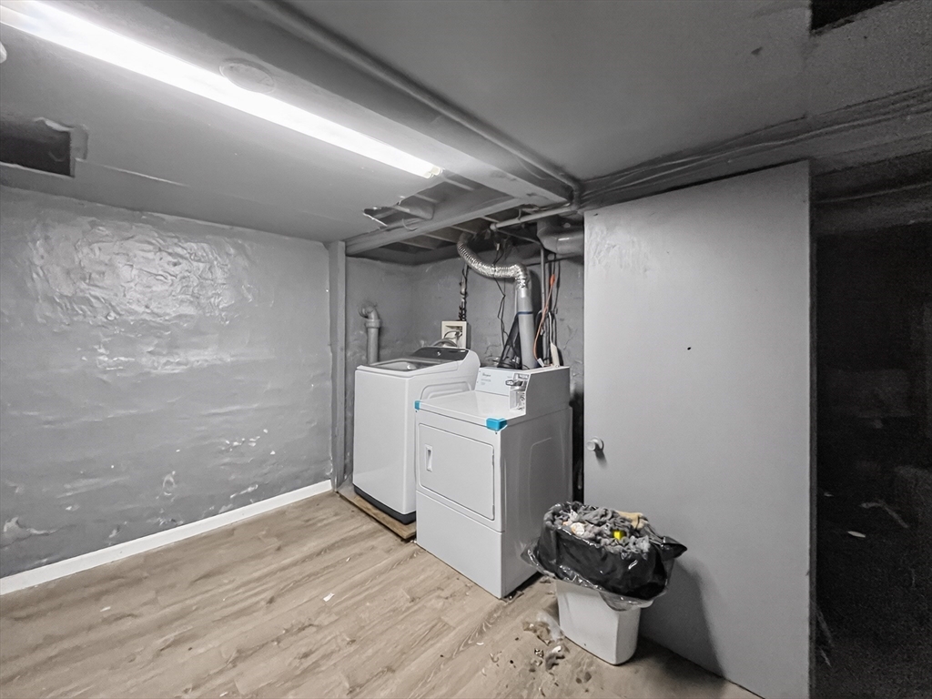 49 Porter Street Somerville, MA 02143 - Photo 33 of 40 a room with water heater and wooden cabinets