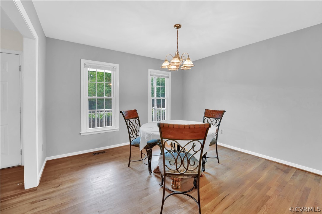 7531 Genuine Risk Lane Midlothian, VA 23112 - Photo 12 of 50 a view of a dining room with furniture a chandelier and wooden floor