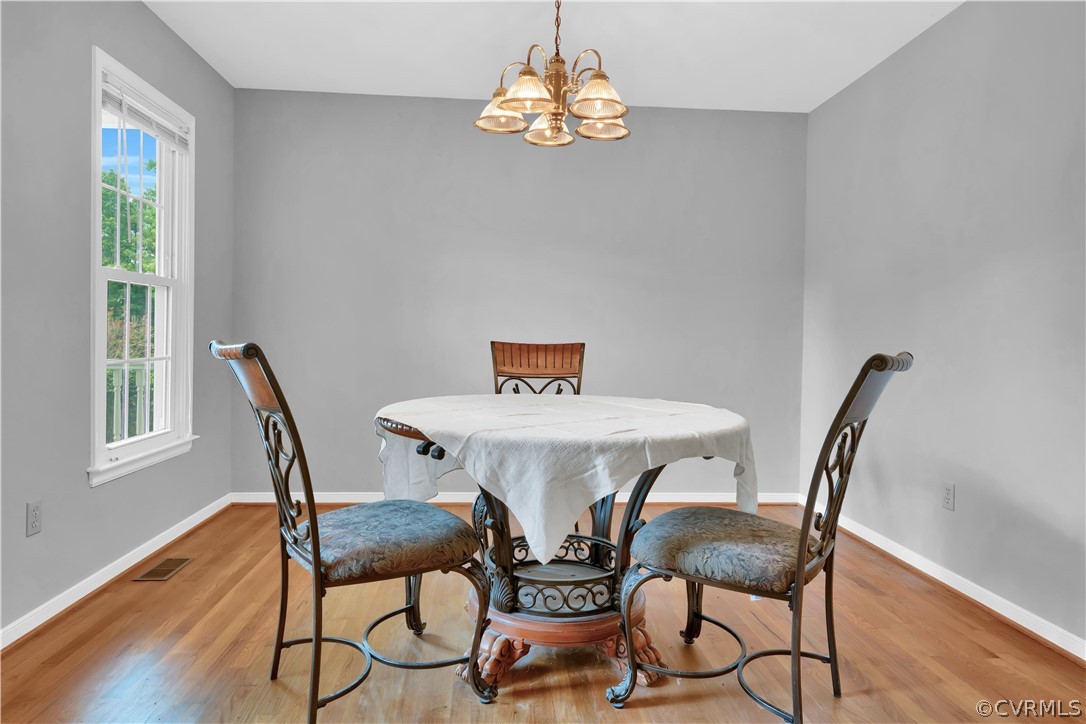 7531 Genuine Risk Lane Midlothian, VA 23112 - Photo 13 of 50 a view of a dining room with furniture window and wooden floor