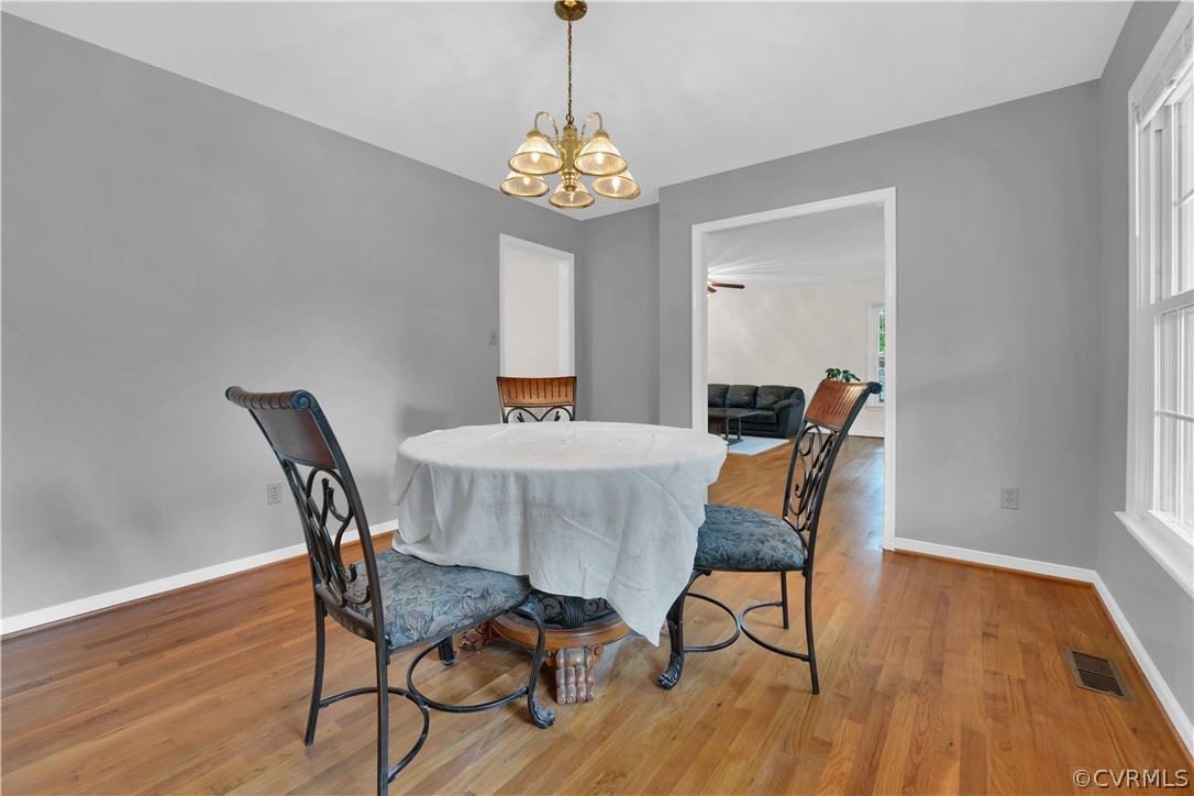 7531 Genuine Risk Lane Midlothian, VA 23112 - Photo 14 of 50 a view of a dining room with furniture and wooden floor