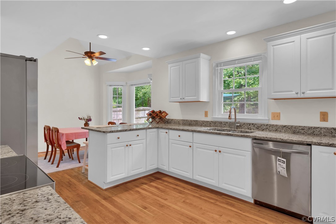 7531 Genuine Risk Lane Midlothian, VA 23112 - Photo 17 of 50 a very nice looking kitchen with granite countertop a stove a sink a dining table and chairs