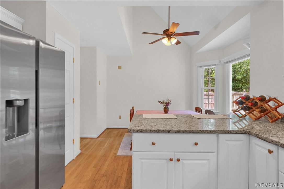 7531 Genuine Risk Lane Midlothian, VA 23112 - Photo 18 of 50 a kitchen with a granite countertop cabinets and a chandelier