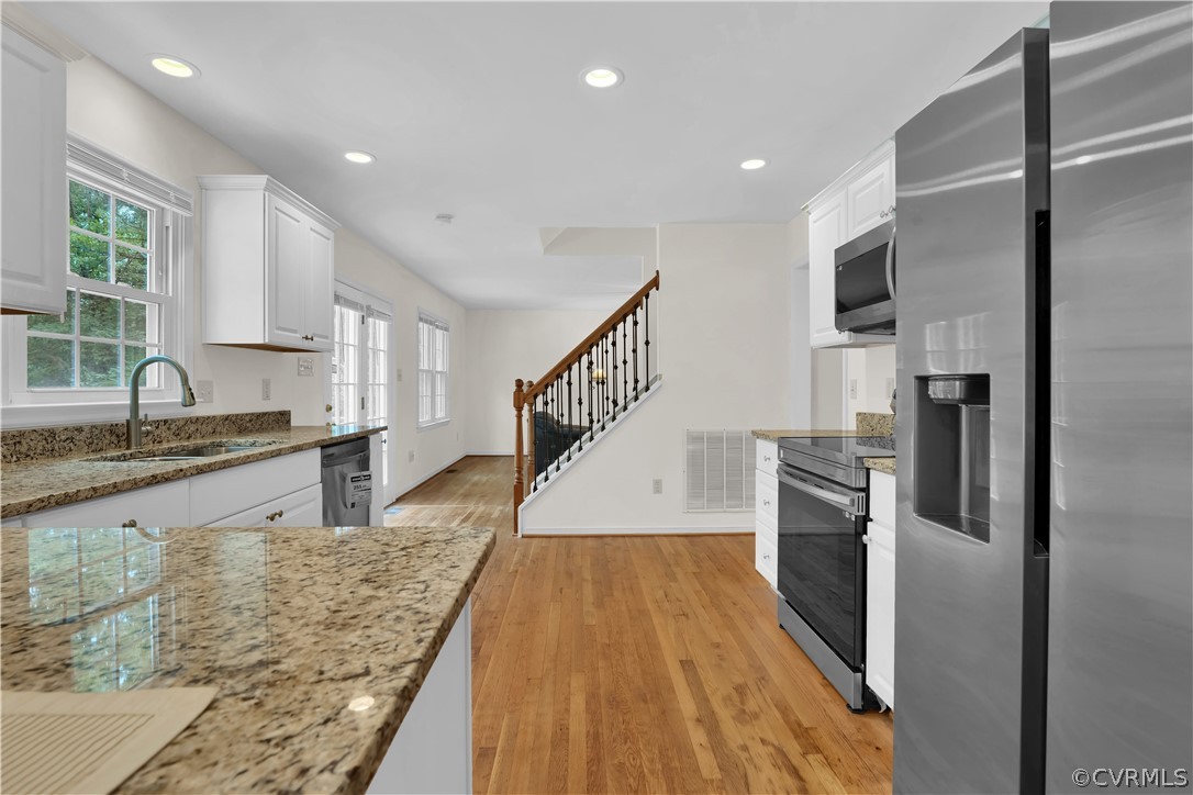 7531 Genuine Risk Lane Midlothian, VA 23112 - Photo 19 of 50 a kitchen with granite countertop a stove and a sink